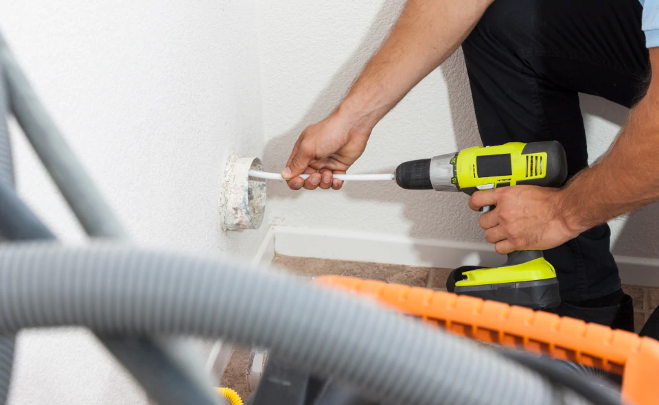 worker doing dryer vent cleaning